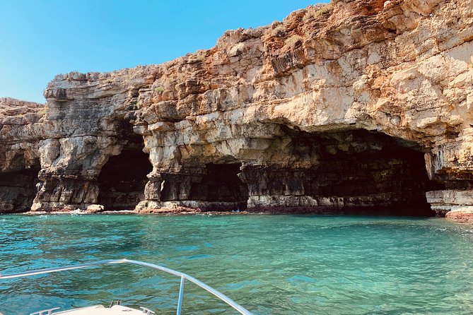 Boat tour of the Polignano a Mare caves with aperitif - Grotta Azzurra under the Santo Stefano Bastion: why the water turns blue