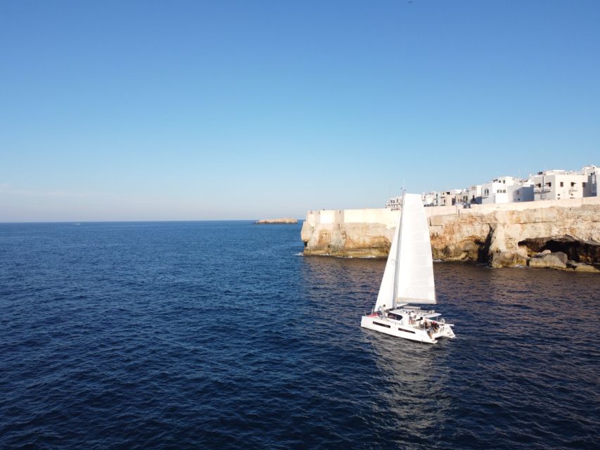 Polignano a Mare: Catamaran Tour with Aperitif & Local Food - Cala Corvino: aperitivo, swimming, and paddleboarding